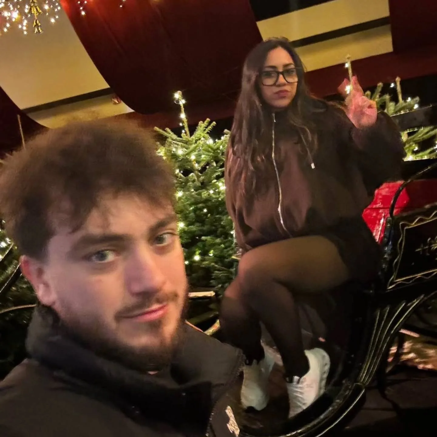 Michalis and Cristal in a sleigh at a Christmas market